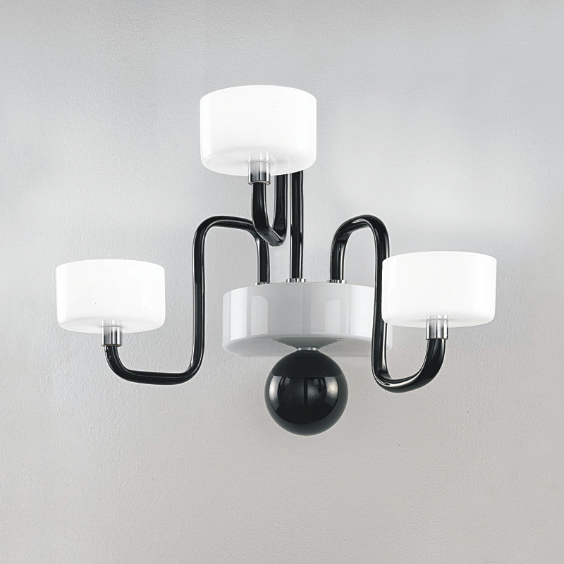 Guggenheim Wall Light by Zaneen Shop - A abstract chandelier with a circle base and three curved arms with attached glass cylinder lights.