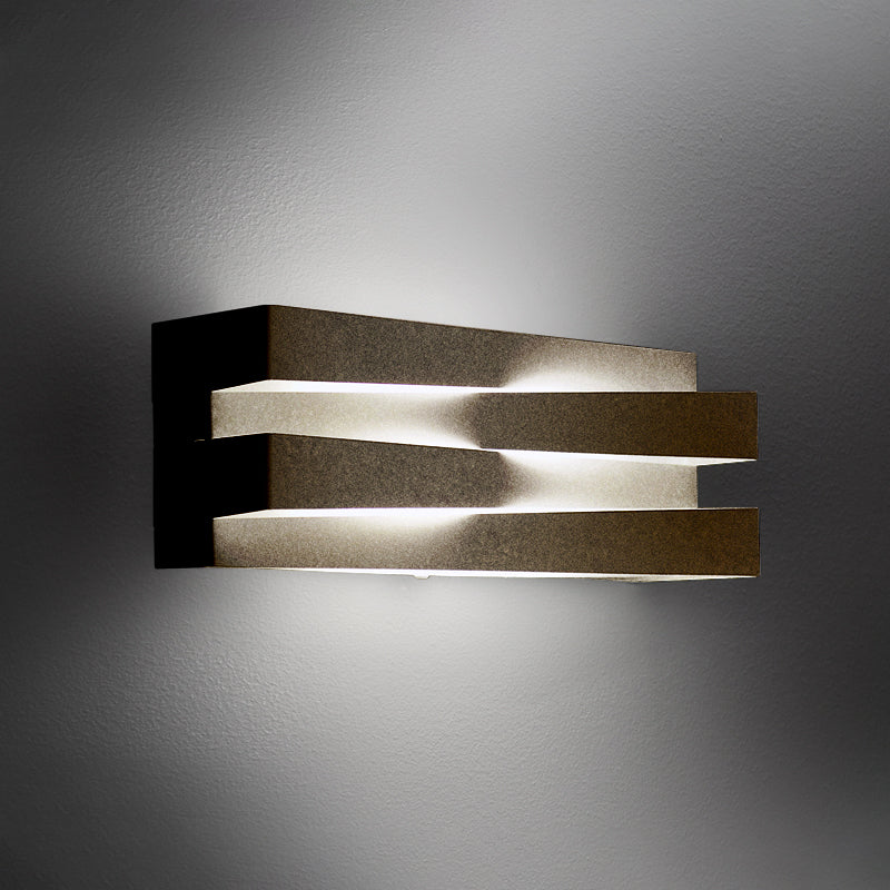 Cross Wall Light by Zaneen Shop - A metallized finished lamp with a laser-cut metal and glass diffuser crisscrossed design providing direct and indirect LED light.