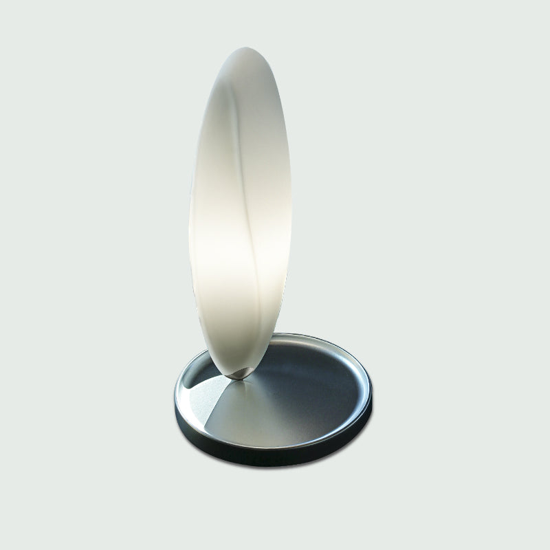 Track Table Lamp by Zaneen Shop - A metallic table lamp that features an oval shape.