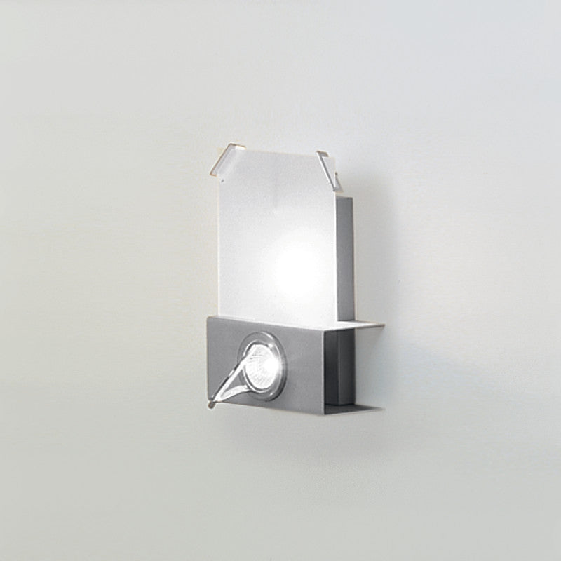 Woody Wall Light by Zaneen Shop - A rectangle shape light fixture. The stainless steel base has a centered circular spotlight.  The upper portion holds a frosted glass rectangle. 