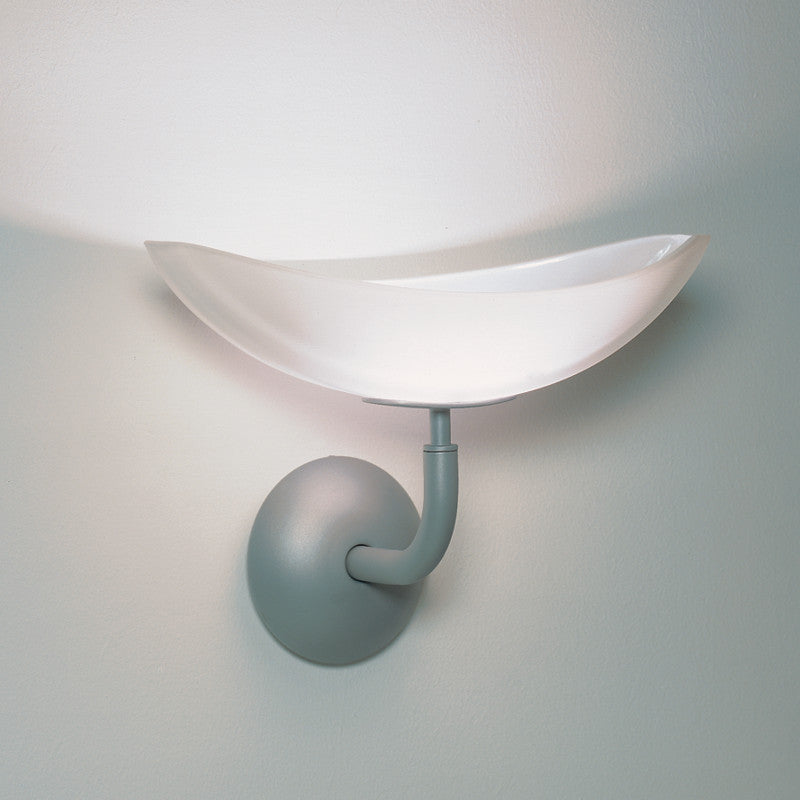Teseo Wall Light by Zaneen Shop - A fixture with a metallic-gray base and glass light shaped as scooped half circle.