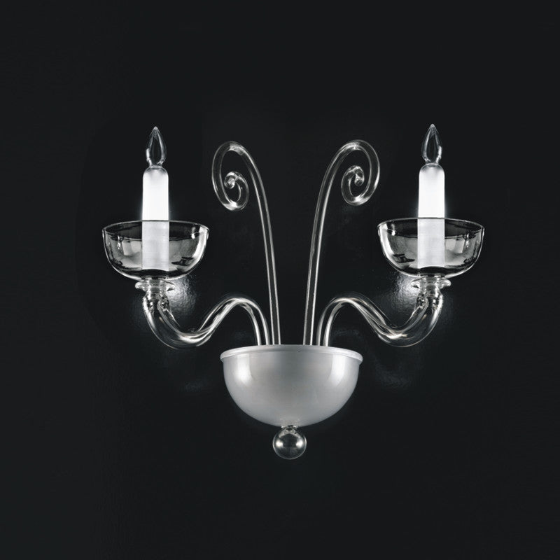 Brera Wall Light by Zaneen Shop - A glass chrome-finished fixture, featuring two paralleled curved arms, each holding a glass candle shaped light.
