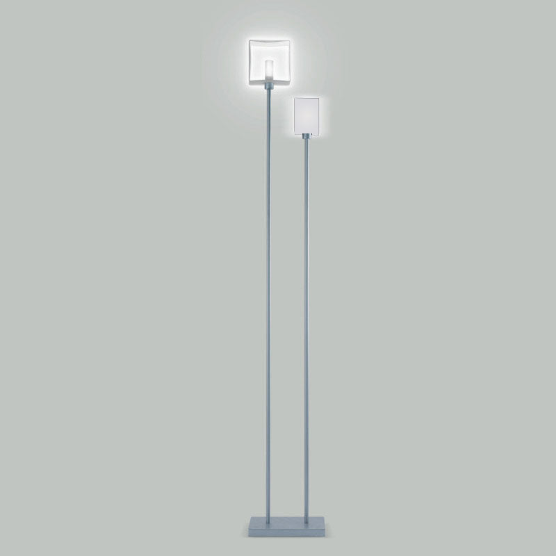 Domino Floor Lamp by Zaneen Shop - A light fixture with two parelleling white hallowed glass cube shaped lights on top of a thin stemmed base. One slight taller than the other to add dimension.